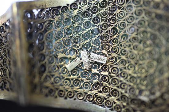 A Chinese silver gilt filigree bracelet inset with three carved jadeite oval foliate panels.